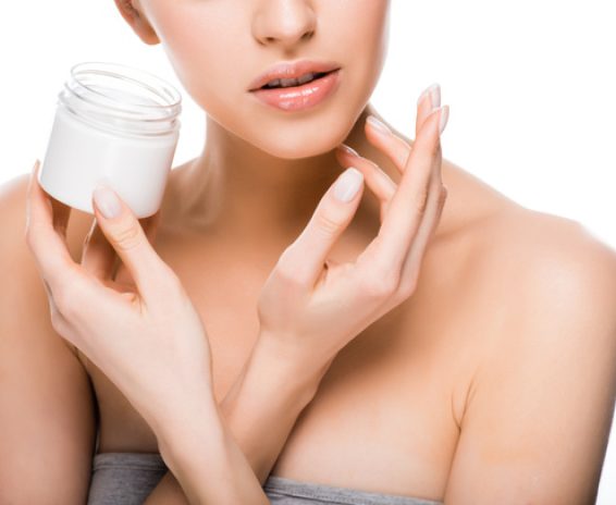 stock-photo-cropped-view-woman-holding-container-while-applying-cosmetic-cream-isolated stock-photo-cropped-view-woman-holding-container-while-applying-cosmetic-cream-isolated